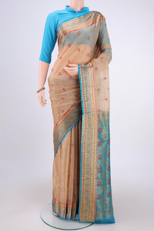 Sea Green Banarasi Tussar Silk Saree with Embroidery on the body and Zari And Thread Border.  displayed on a mannequin