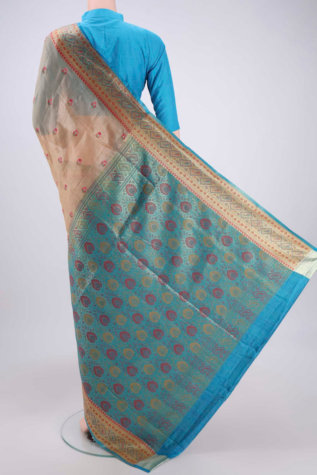 Flat view of Sea Green Banarasi Tussar Silk Saree with Embroidery on the body and Zari And Thread Border. 