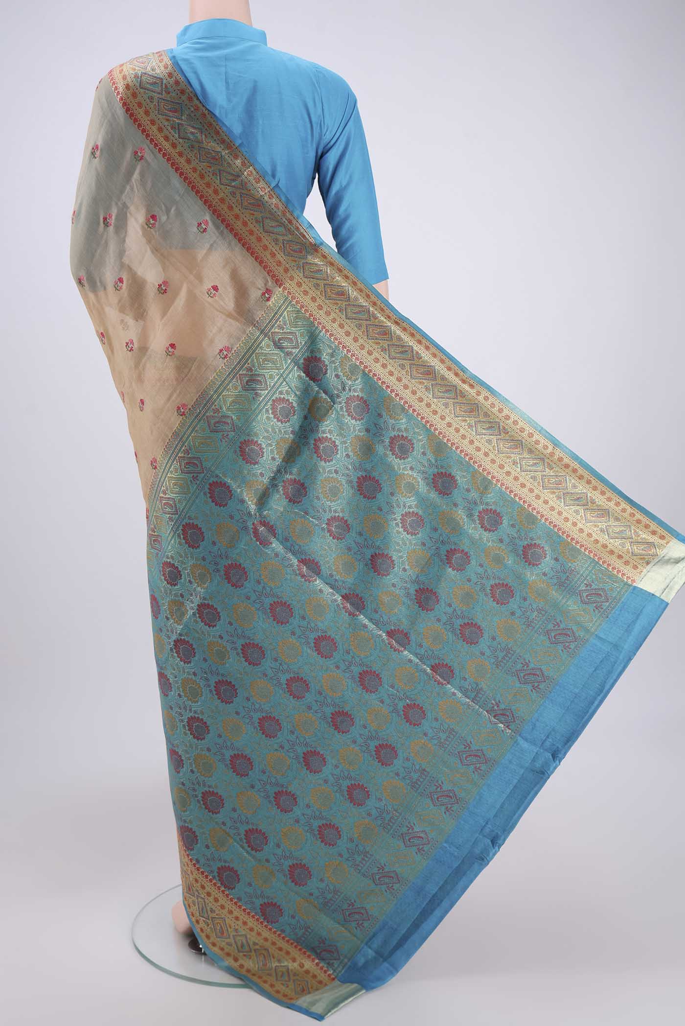 Flat view of Sea Green Banarasi Tussar Silk Saree with Embroidery on the body and Zari And Thread Border. 