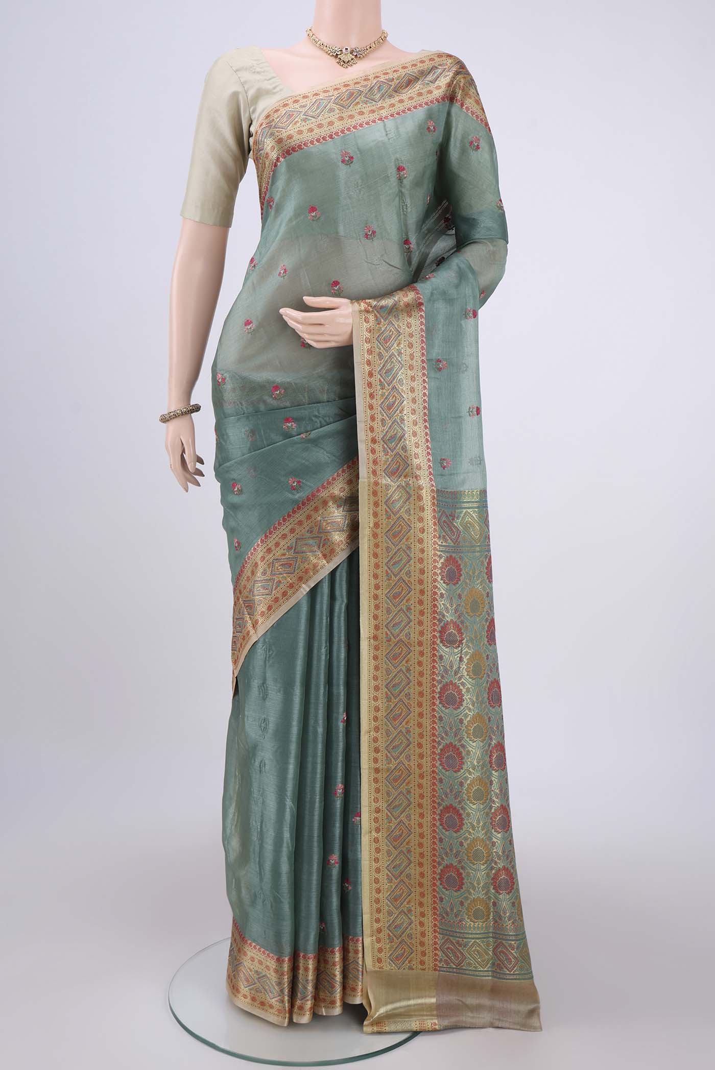 Light Green Banarasi Tussar Silk Saree with Embroidery on the body and Zari And Thread Border.  displayed on a mannequin