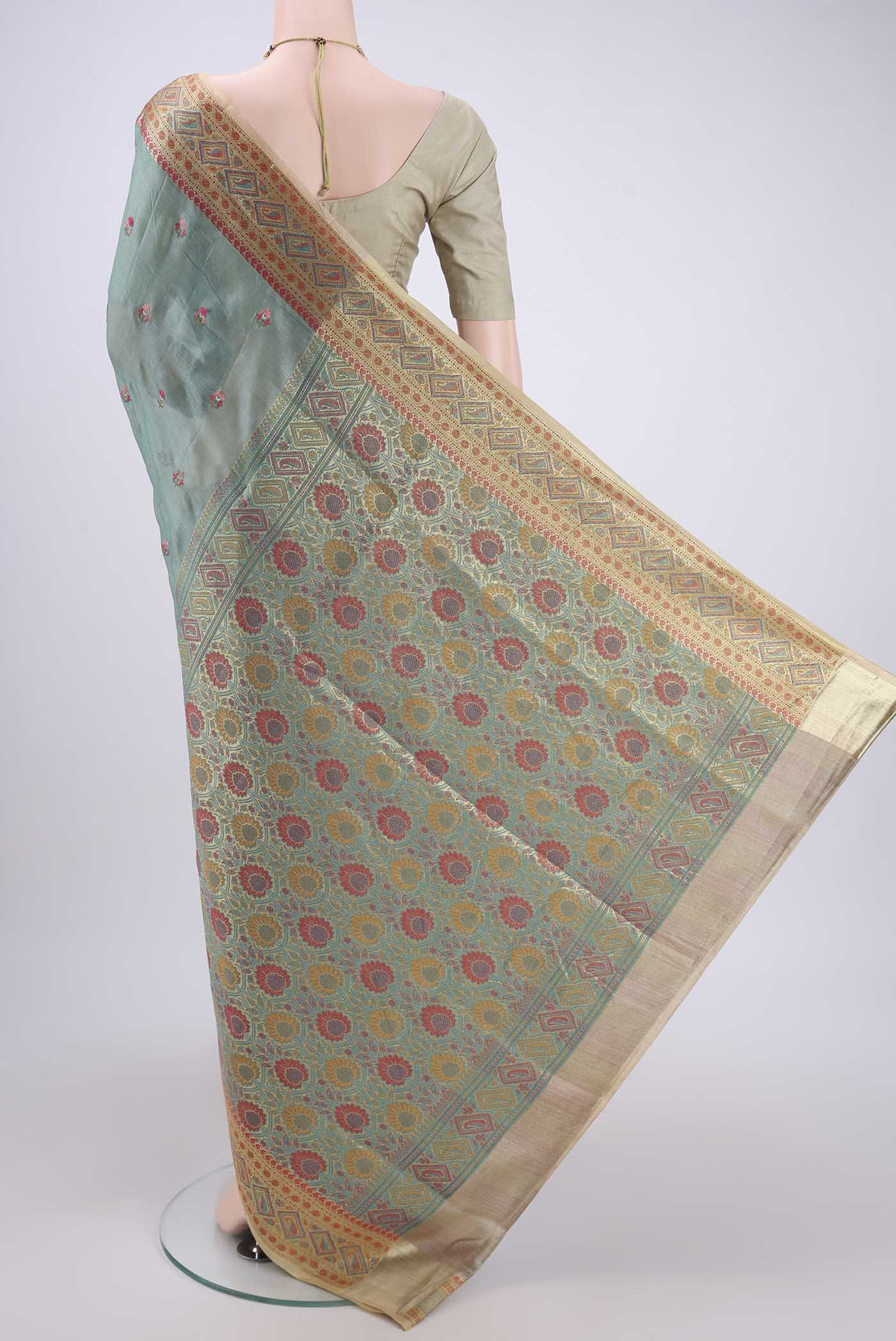 Flat view of Light Green Banarasi Tussar Silk Saree with Embroidery on the body and Zari And Thread Border. 