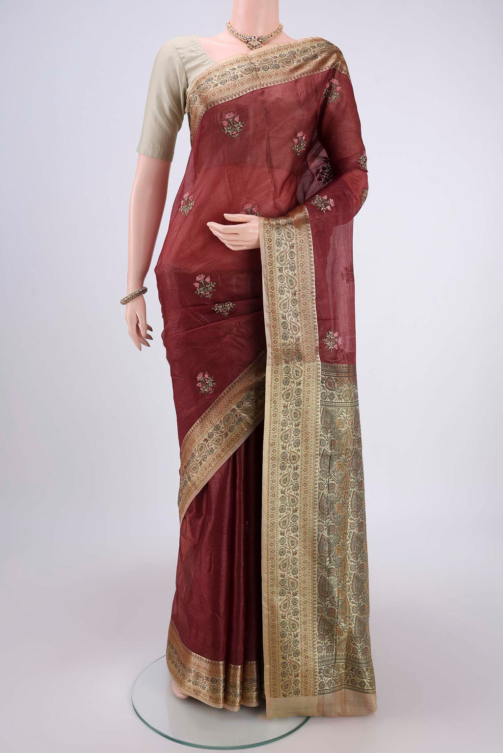 Brown Banarasi Tussar Silk Saree with Embroidery on the body and Zari And Thread Border.  displayed on a mannequin