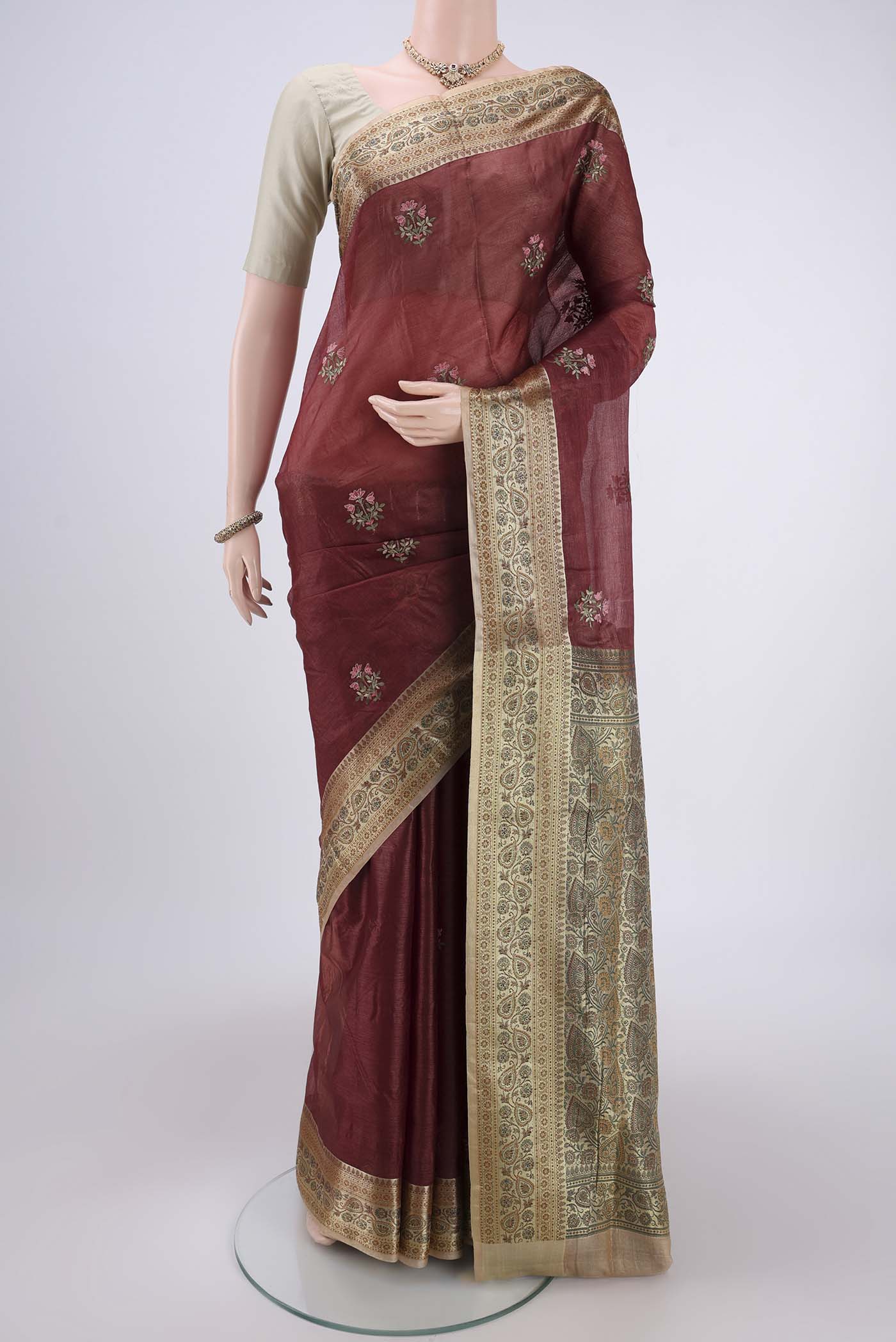 Brown Banarasi Tussar Silk Saree with Embroidery on the body and Zari And Thread Border.  displayed on a mannequin