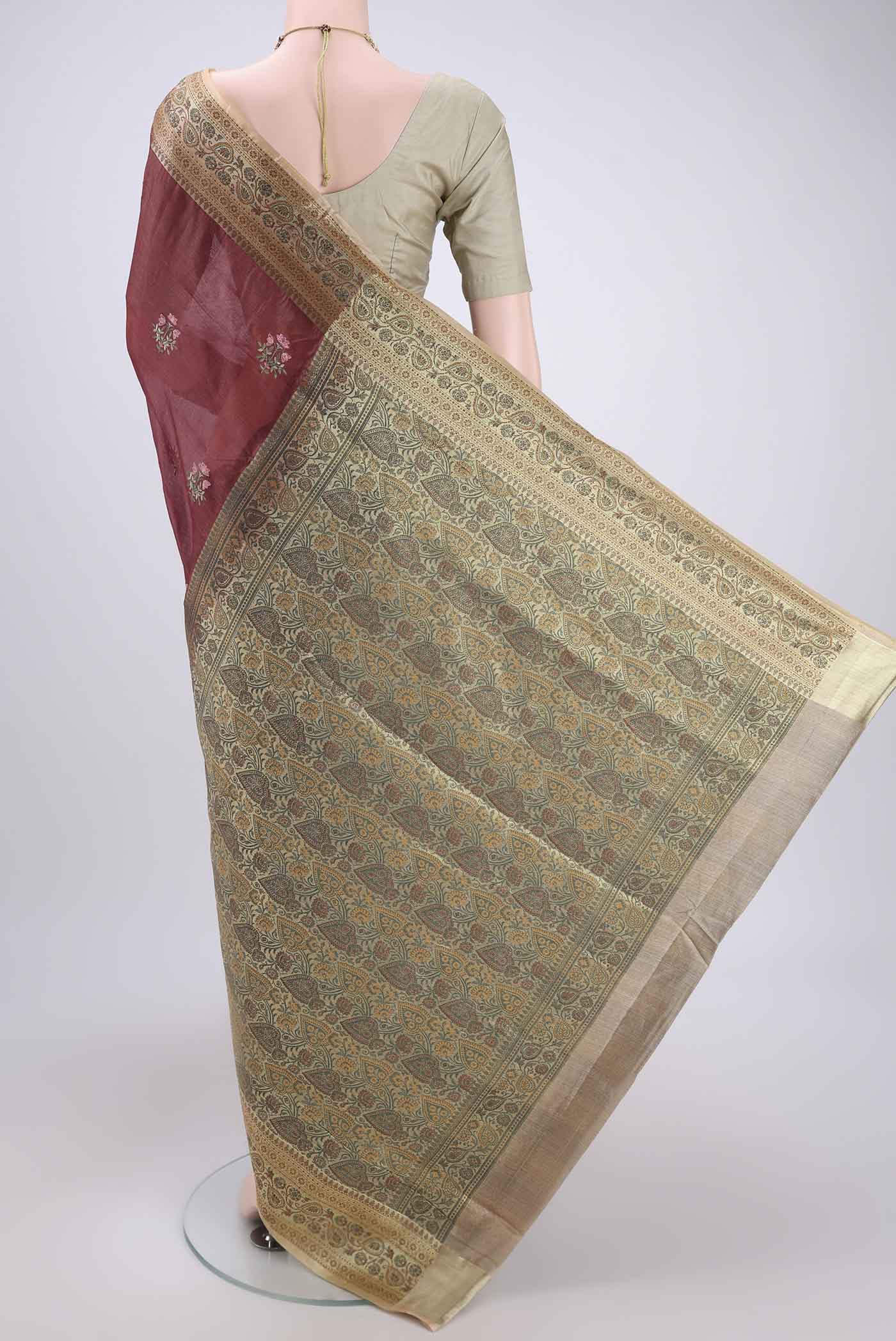 Flat view of Brown Banarasi Tussar Silk Saree with Embroidery on the body and Zari And Thread Border. 