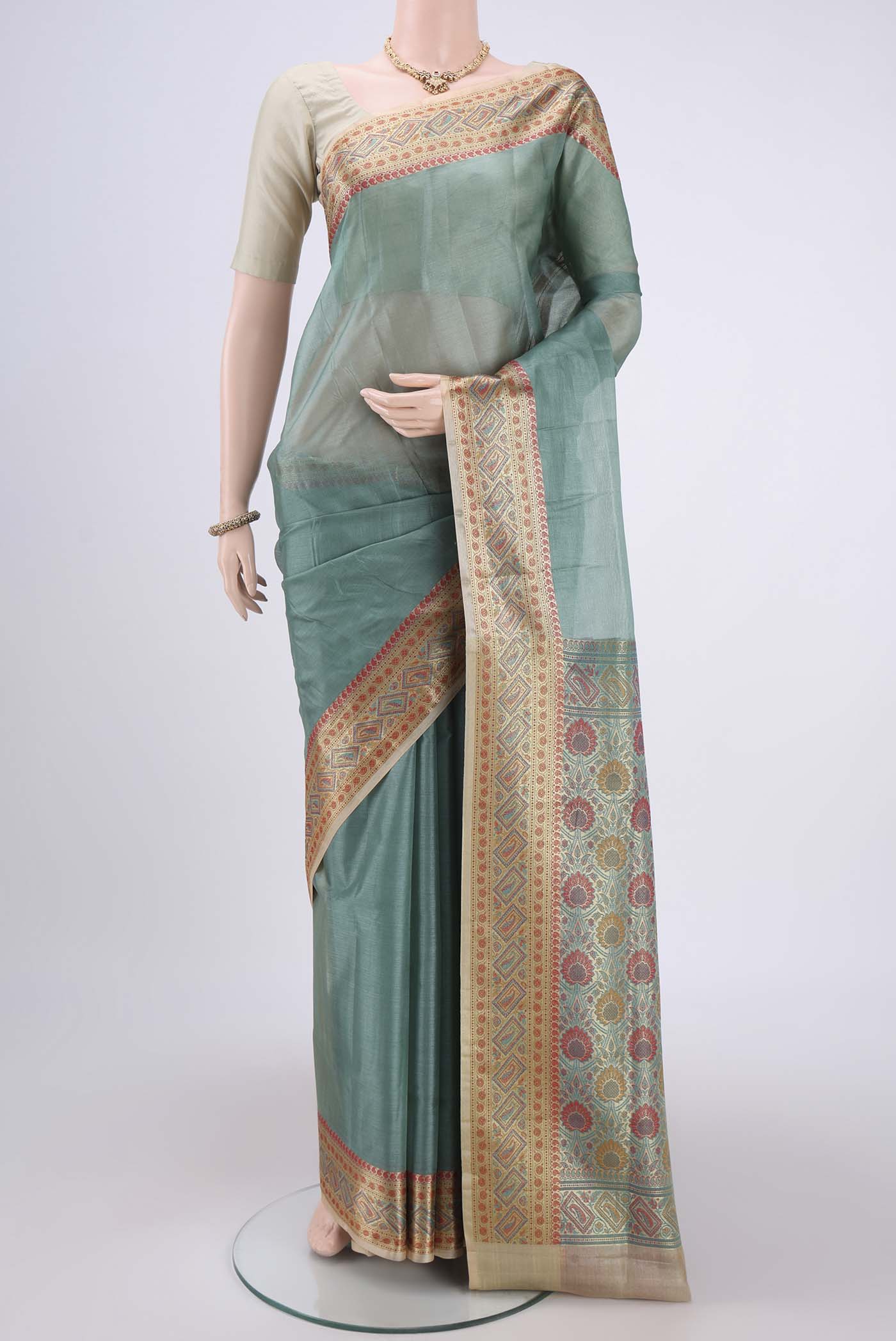 Pickle Green Dual Tone Maheshwari Silk Cotton Saree with Plain Body and Zari Border.  displayed on a mannequin