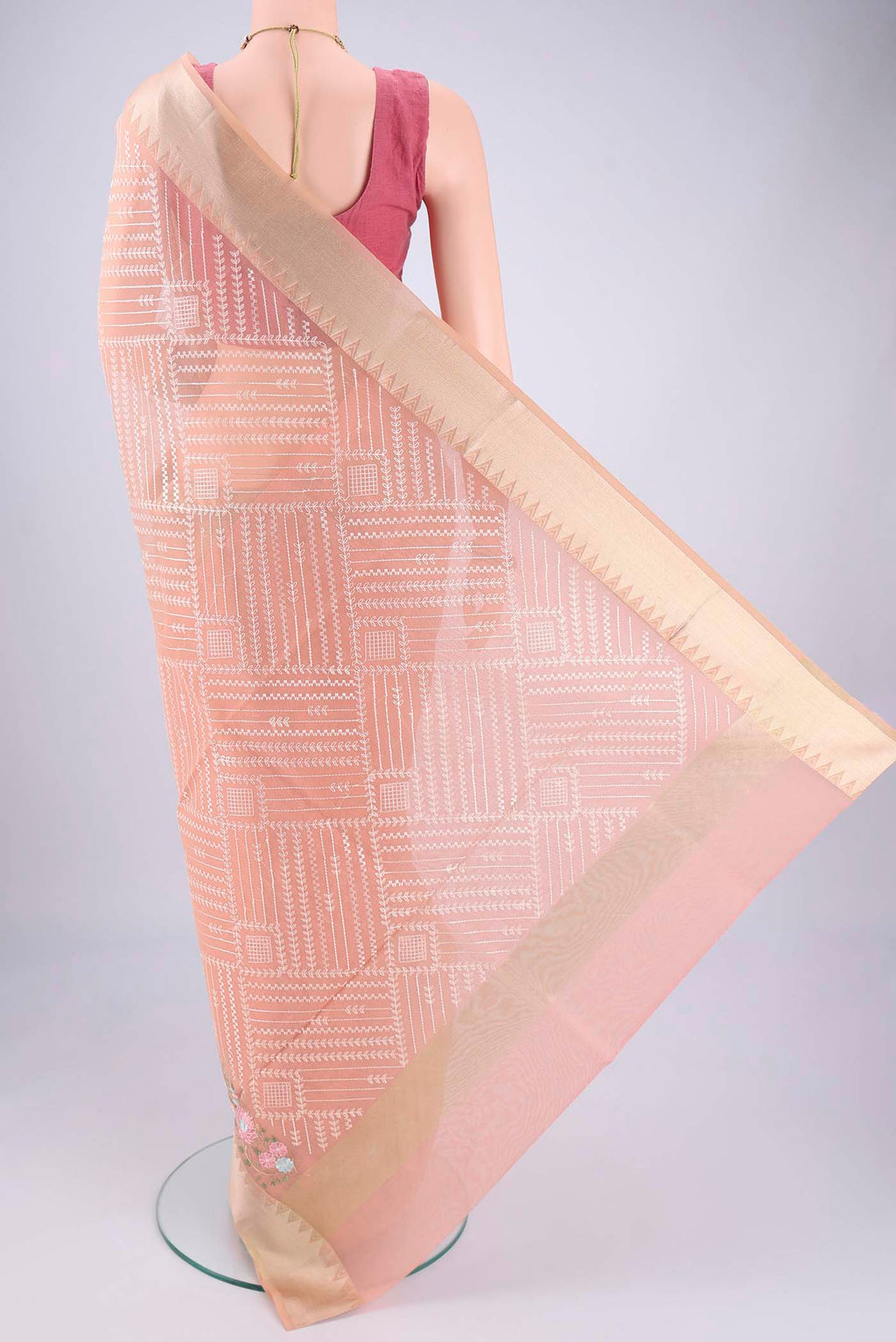 Flat view of Peach Blended Kota Cotton Saree with Embroidery on the body and Zari Border. 