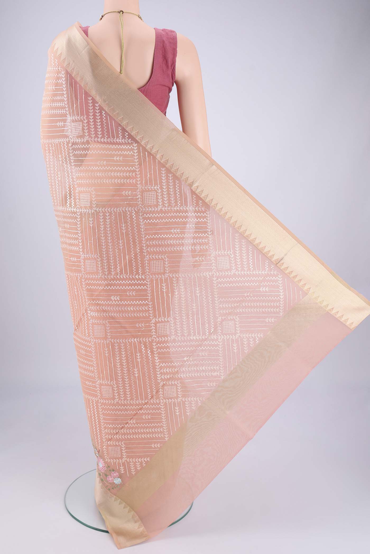 Flat view of Peach Blended Kota Cotton Saree with Embroidery on the body and Zari Border. 