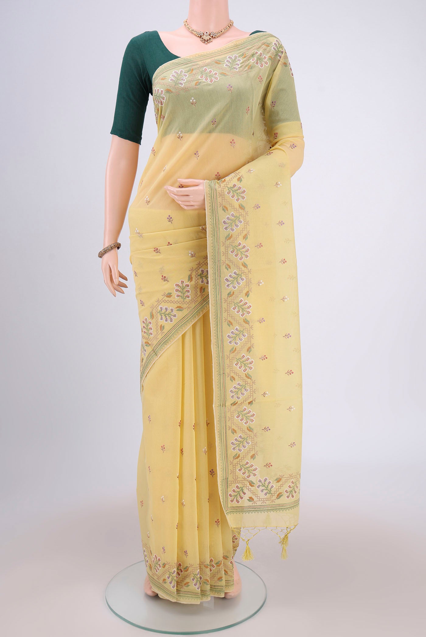 Yellow Kota Cotton Saree with Embroidery on the body and Thread Border.  displayed on a mannequin