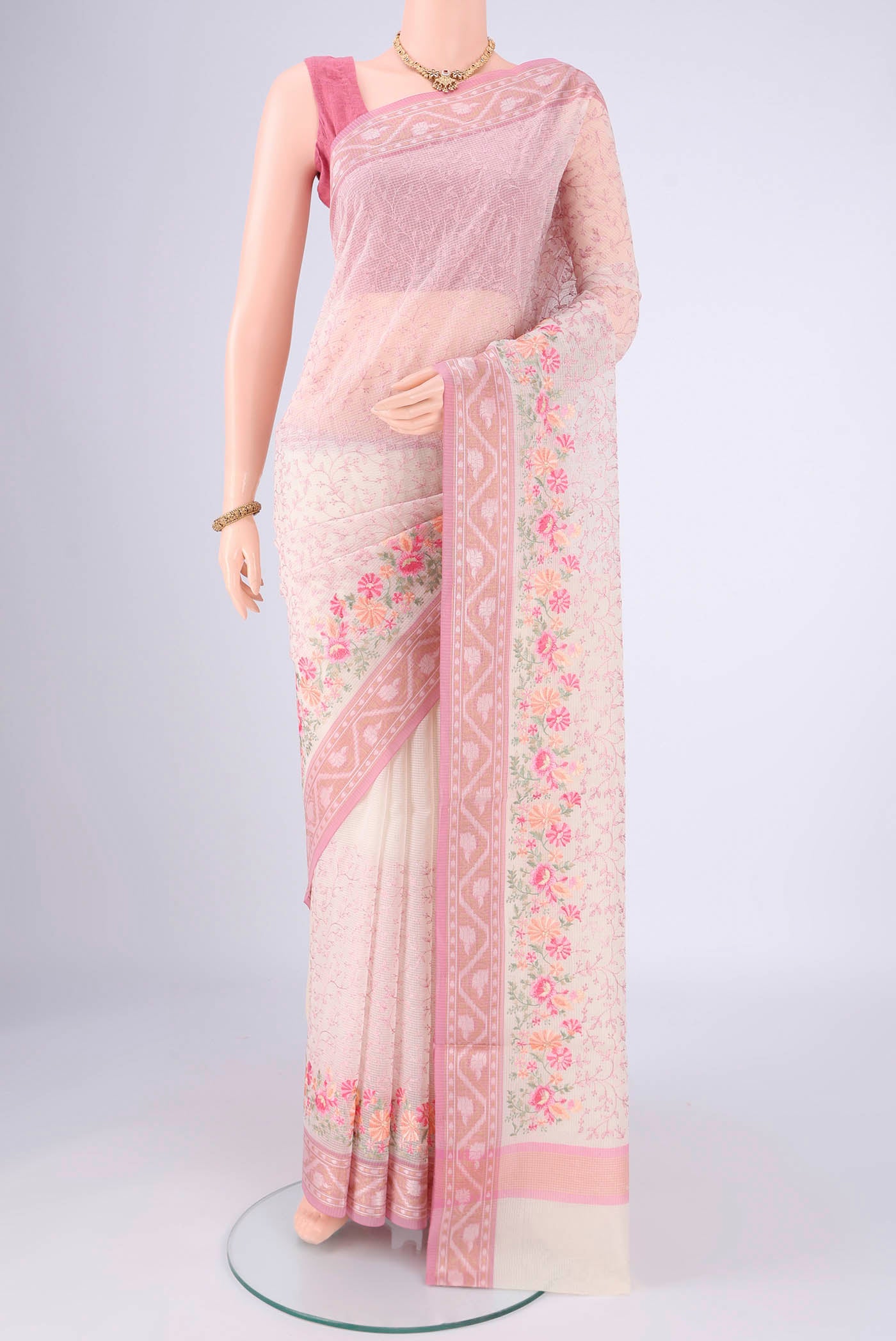 White Blended Kota Cotton Saree with Embroidery on the body and Zari Border.  displayed on a mannequin