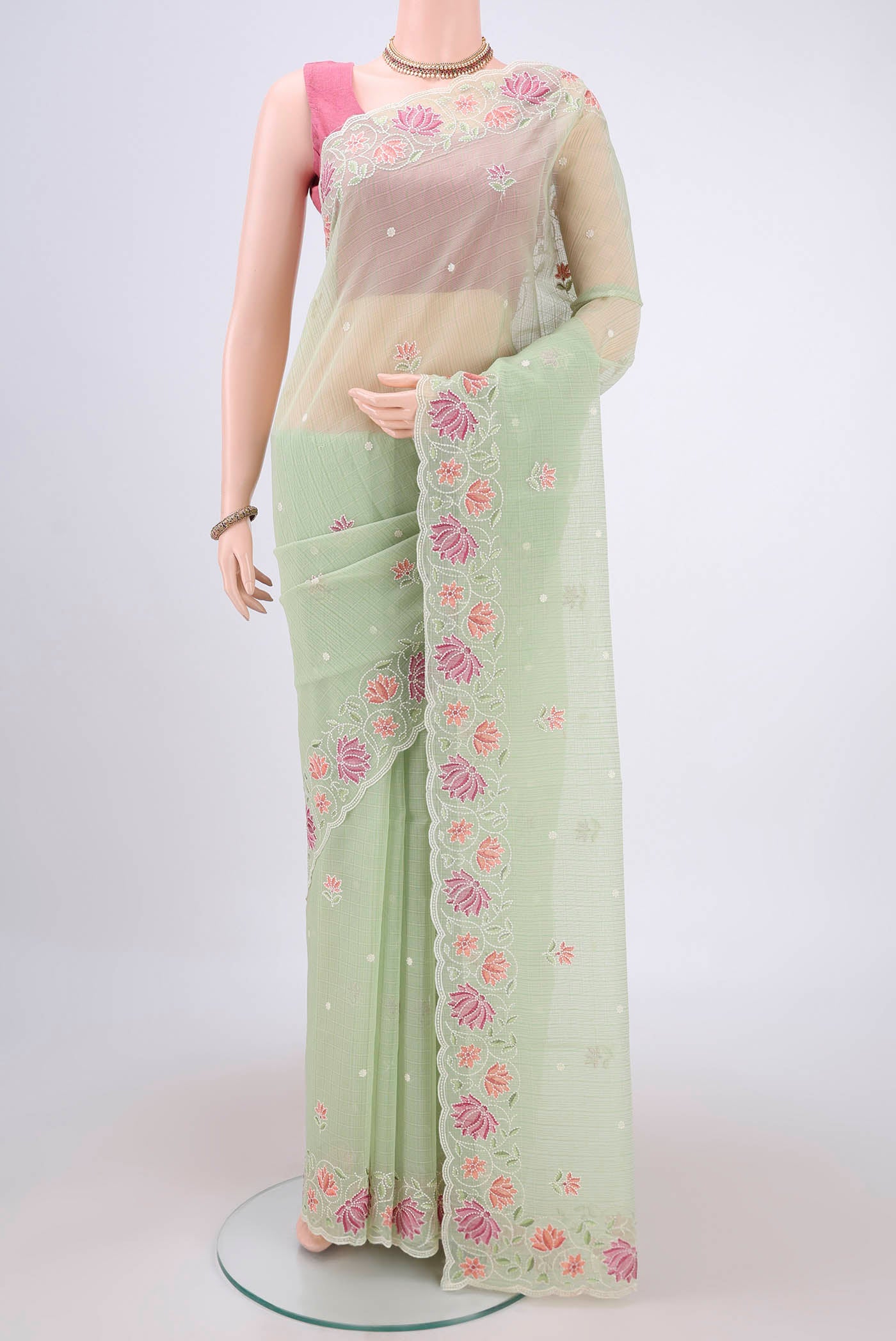 Light Green Kota Cotton Saree with Embroidery on the body and Thread Border.  displayed on a mannequin