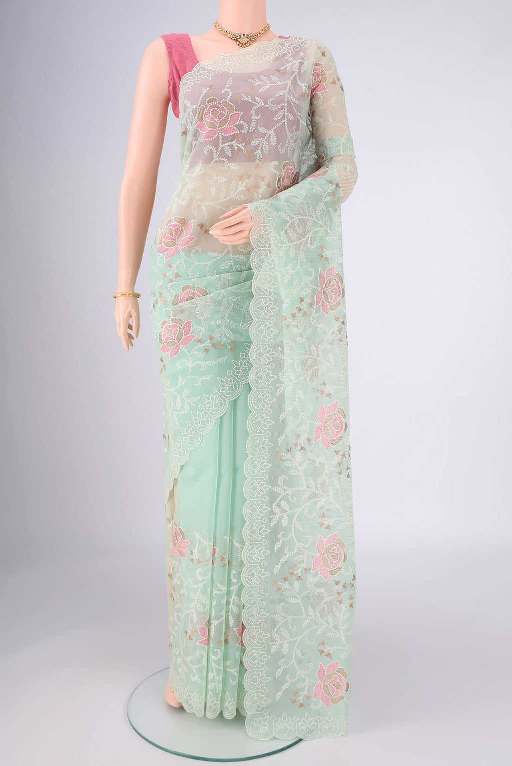 Mint Green Blended Kota Cotton Saree with Embroidery on the body and Thread Border.  displayed on a mannequin