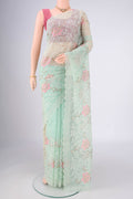 Mint Green Blended Kota Cotton Saree with Embroidery on the body and Thread Border.  displayed on a mannequin