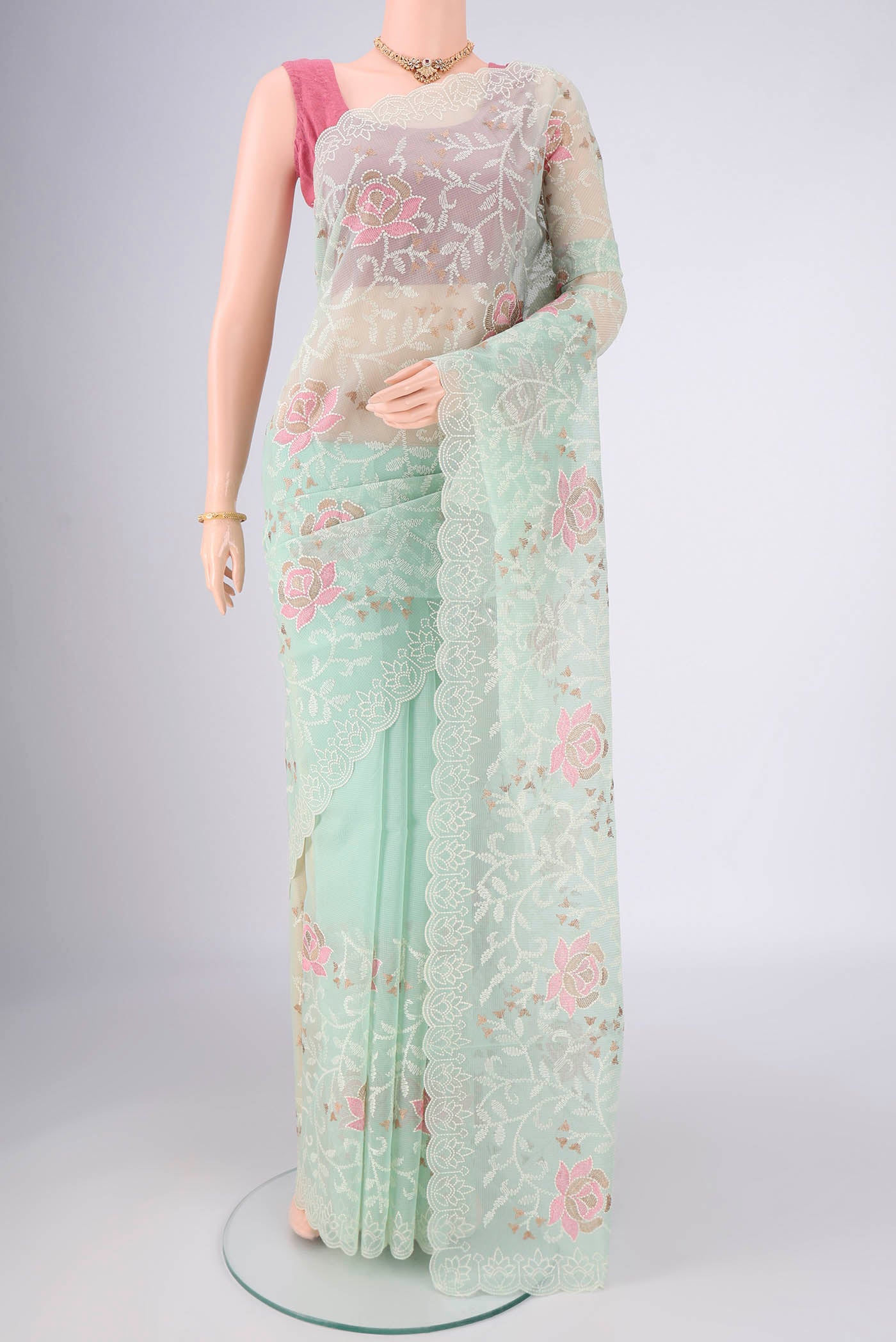 Mint Green Blended Kota Cotton Saree with Embroidery on the body and Thread Border.  displayed on a mannequin