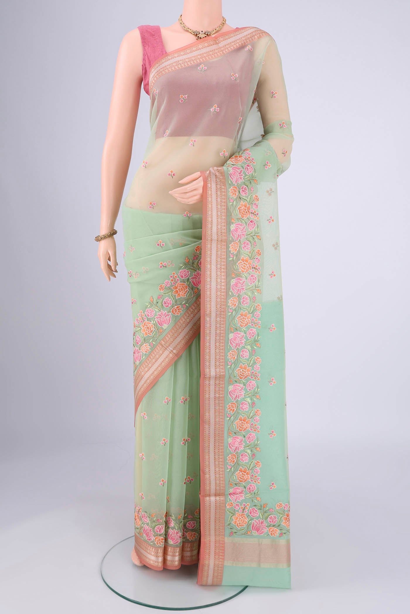 Mint Green Blended Kota Cotton Saree with Embroidery on the body and Zari Border.  displayed on a mannequin