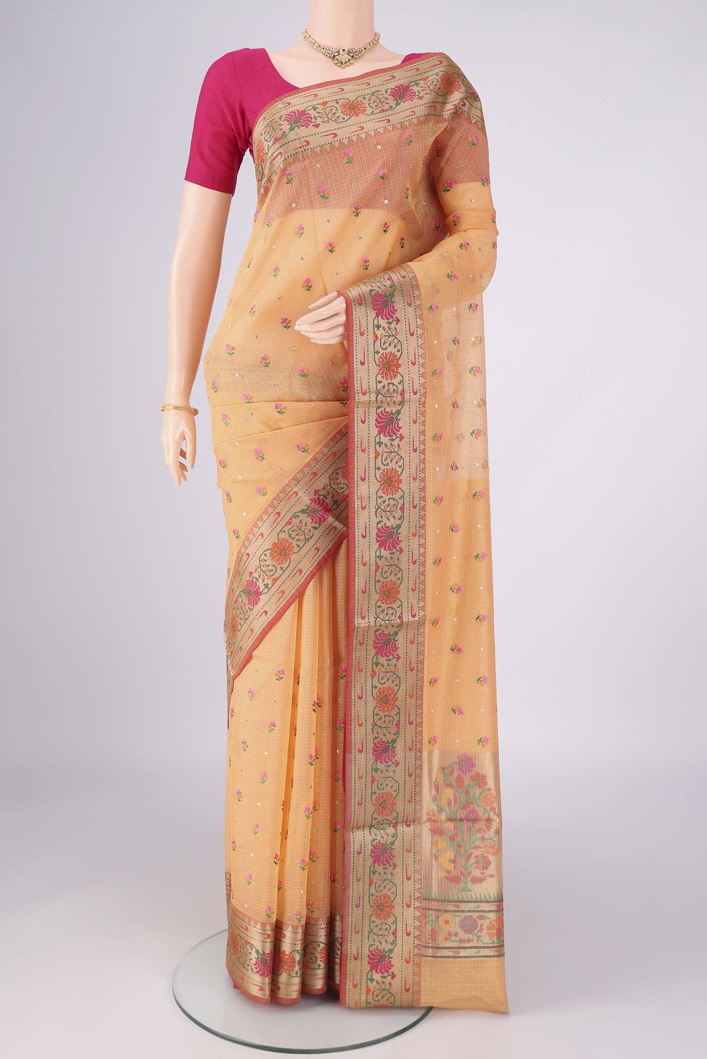 Orange Blended Kota Cotton Saree with Embroidery on the body and Zari Border.  displayed on a mannequin