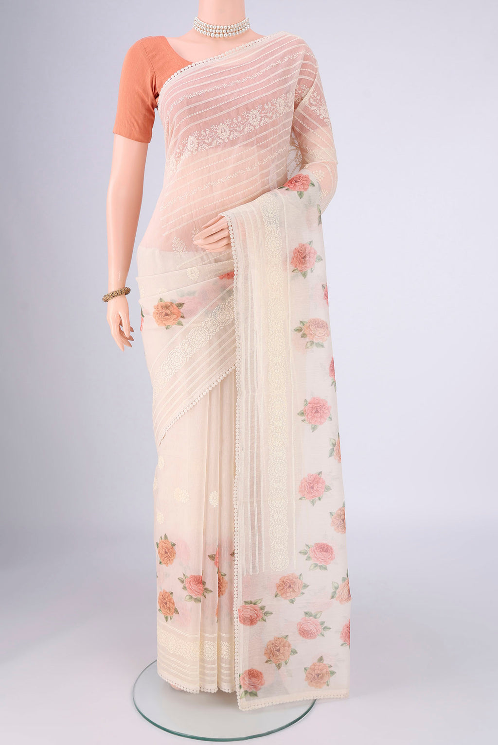 Off White Blended Kota Cotton Saree with Printed design on the body and Embroidery Border.  displayed on a mannequin
