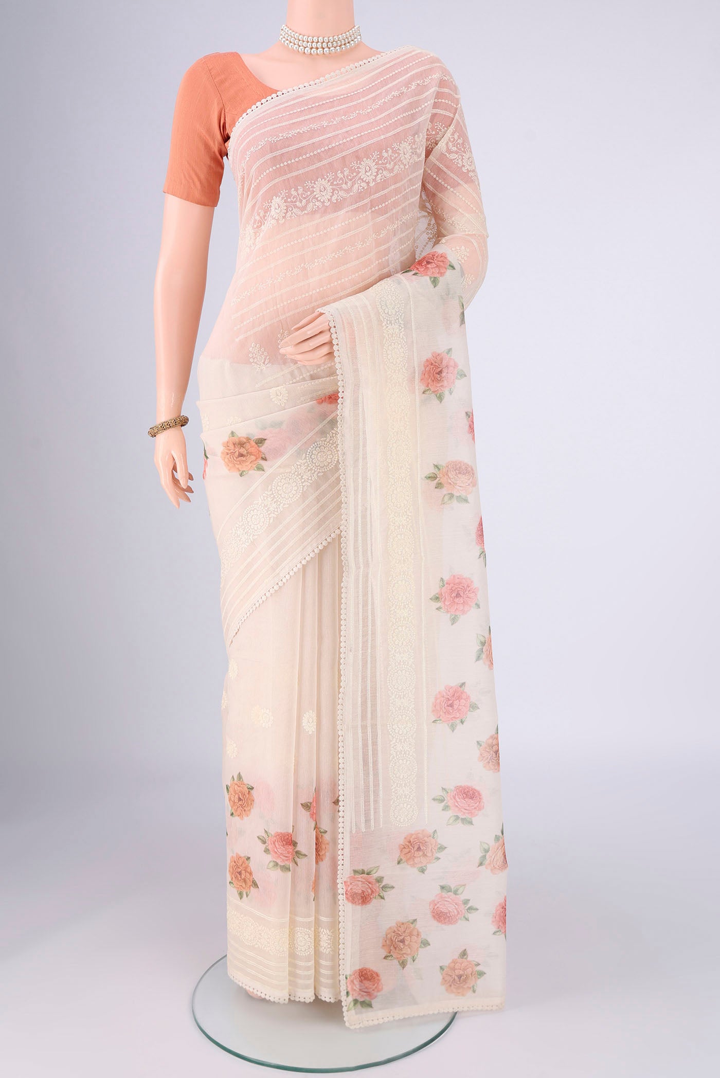 Off White Blended Kota Cotton Saree with Printed design on the body and Embroidery Border.  displayed on a mannequin