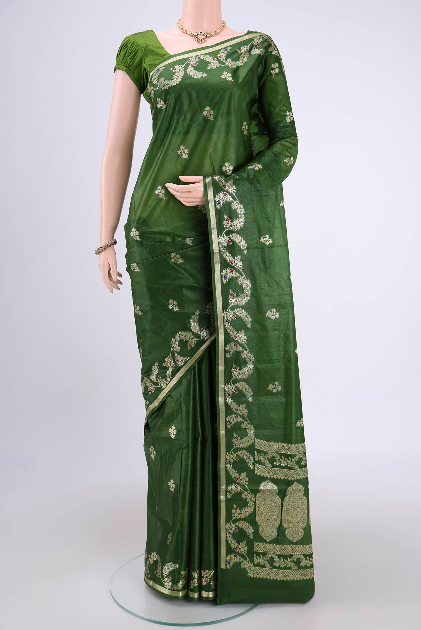 Green Banarasi Tussar Silk Saree with Zari And Thread Butta on the body and Zari And Thread Border.  displayed on a mannequin