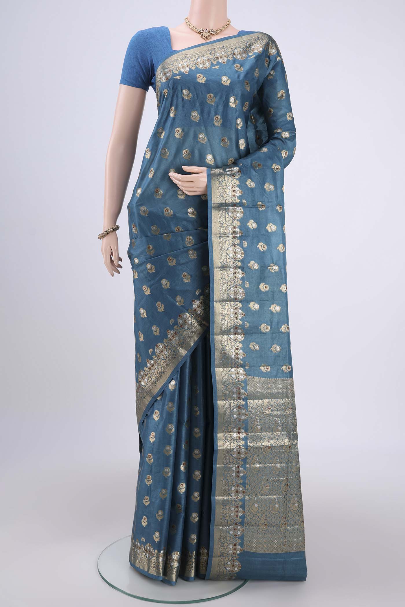 Electric Blue Banarasi Tussar Silk Saree with Zari And Thread Butta on the body and Zari And Thread Border.  displayed on a mannequin
