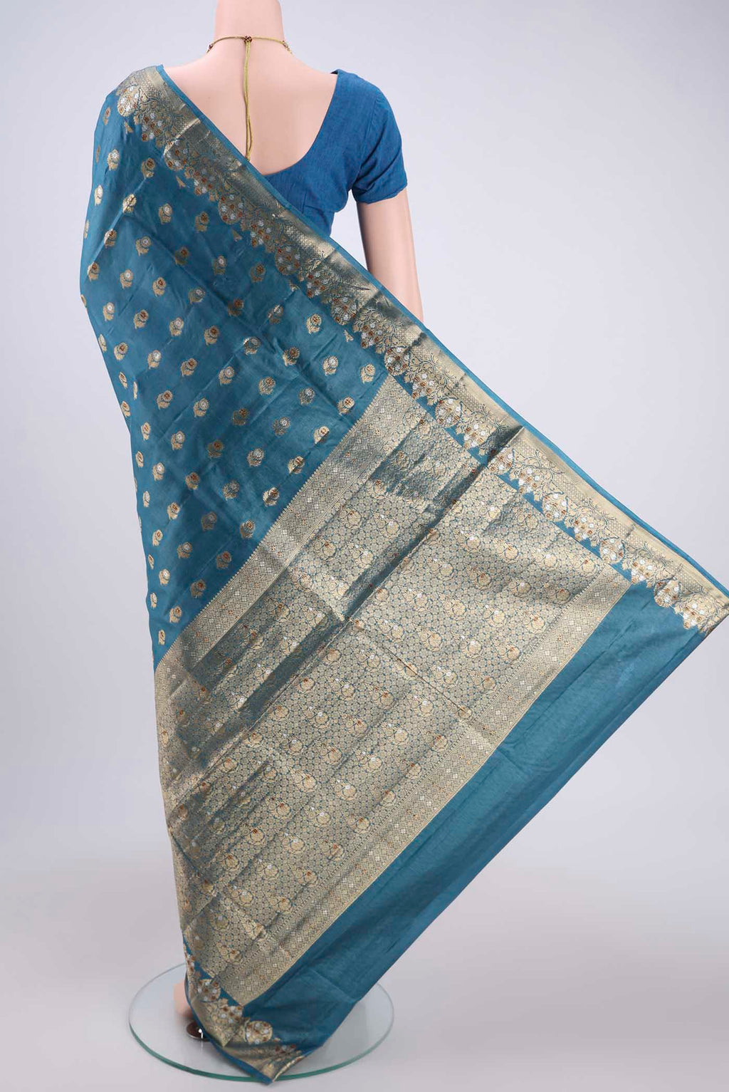 Flat view of Electric Blue Banarasi Tussar Silk Saree with Zari And Thread Butta on the body and Zari And Thread Border. 