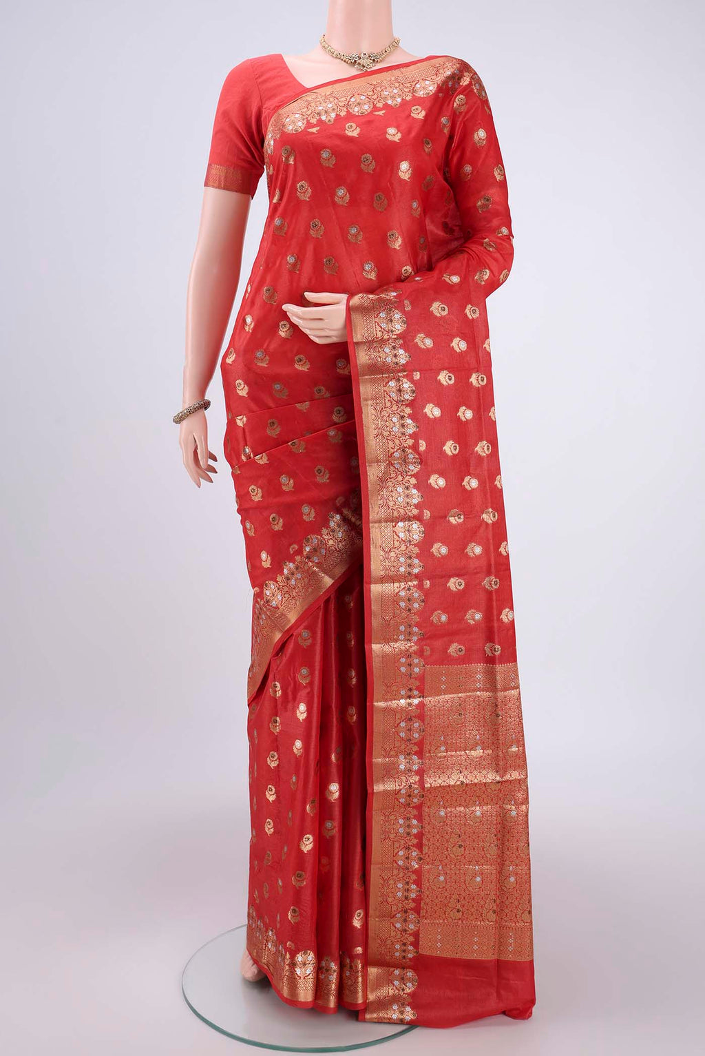 Orange Banarasi Tussar Silk Saree with Zari And Thread Butta on the body and Zari And Thread Border.  displayed on a mannequin