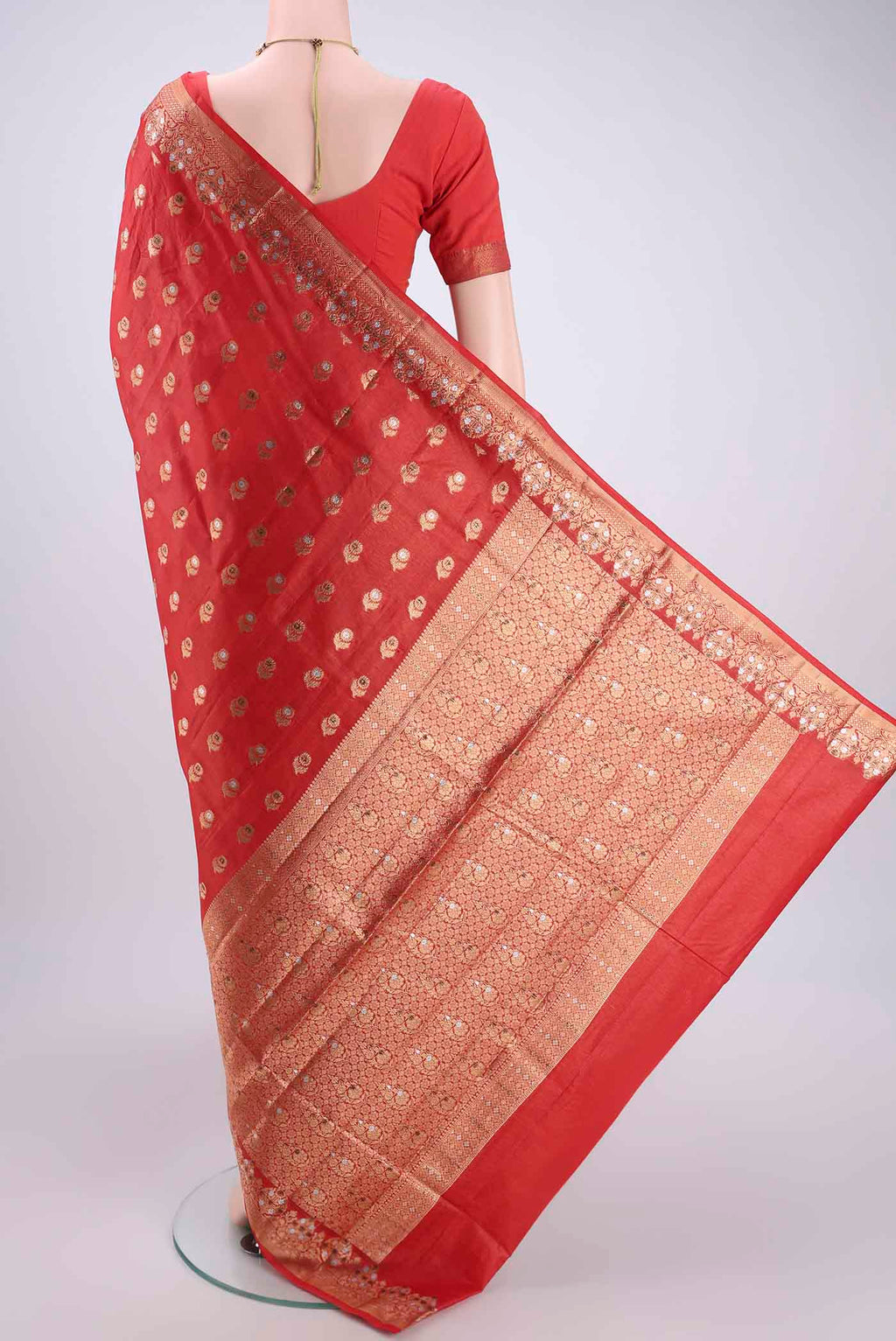 Flat view of Orange Banarasi Tussar Silk Saree with Zari And Thread Butta on the body and Zari And Thread Border. 