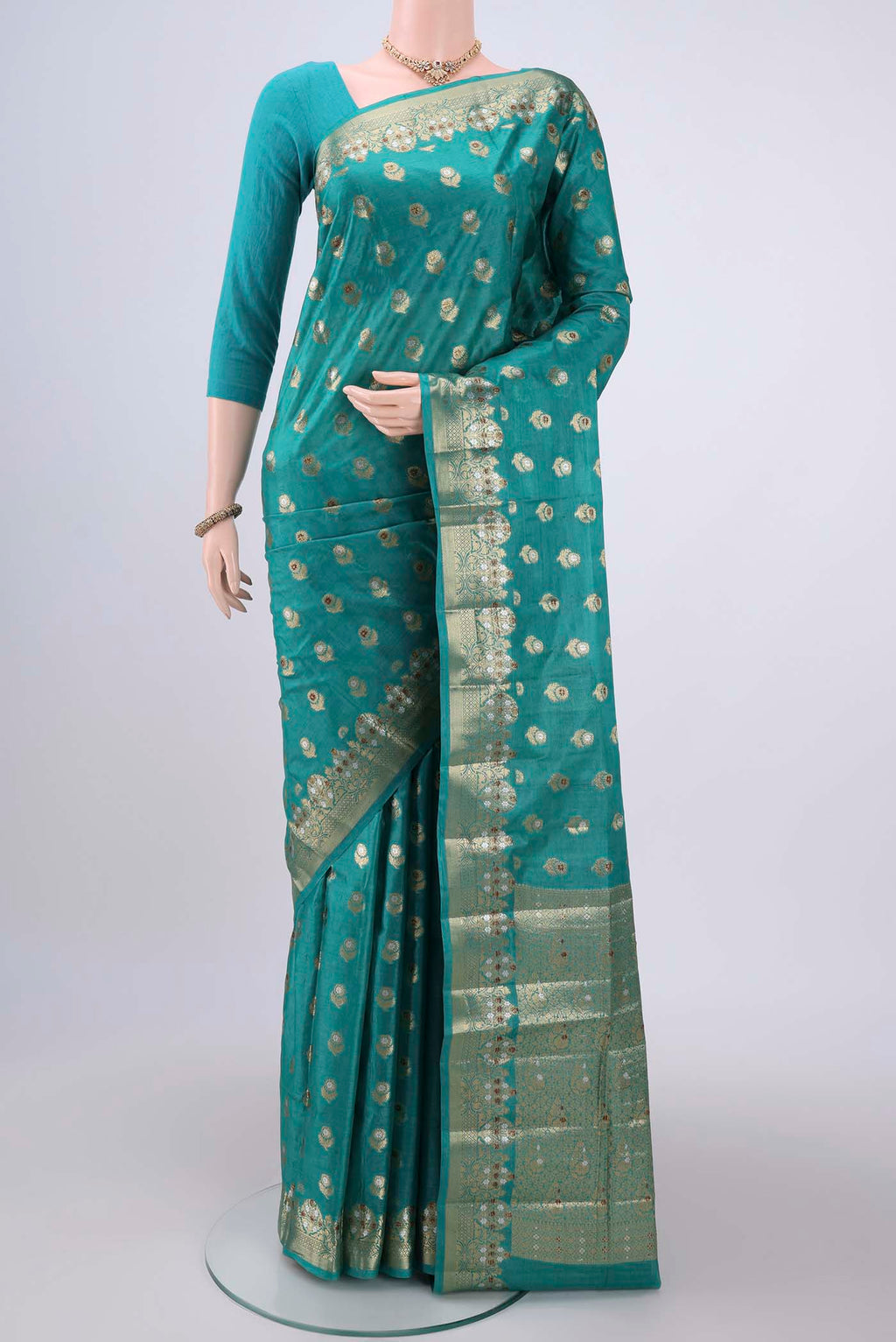 Turquoise Banarasi Tussar Silk Saree with Zari And Thread Butta on the body and Zari And Thread Border.  displayed on a mannequin