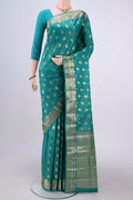 Turquoise Banarasi Tussar Silk Saree with Zari And Thread Butta on the body and Zari And Thread Border.  displayed on a mannequin