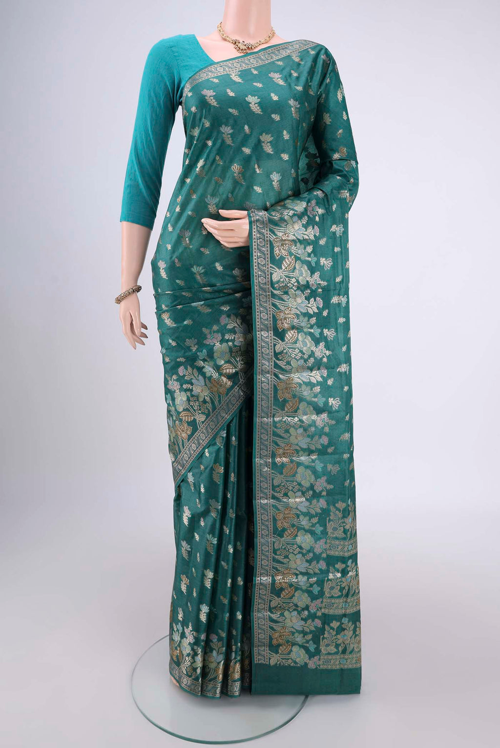 Sea Green Banarasi Tussar Silk Saree with Zari And Thread Butta on the body and Zari And Thread Border.  displayed on a mannequin