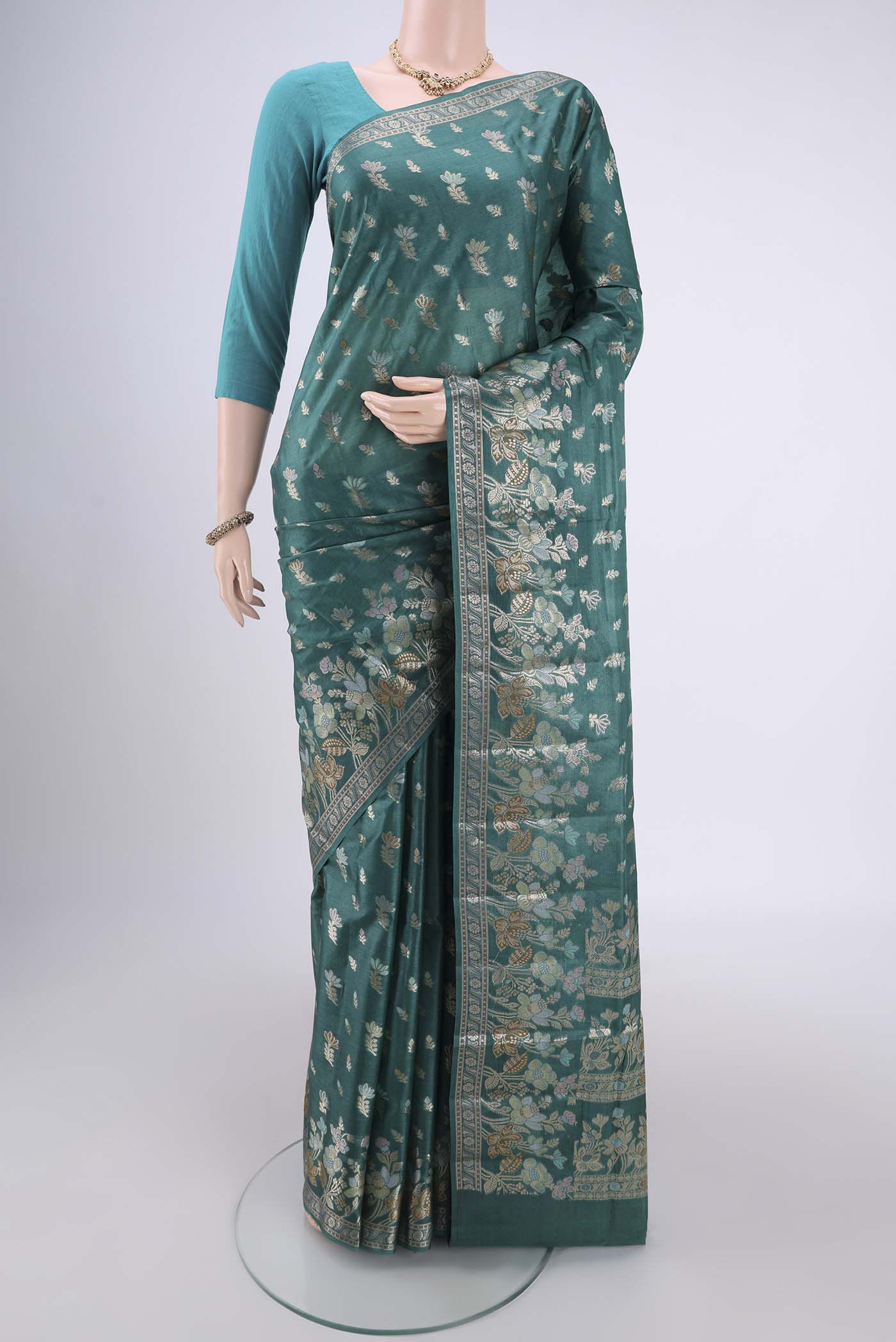 Sea Green Banarasi Tussar Silk Saree with Zari And Thread Butta on the body and Zari And Thread Border.  displayed on a mannequin