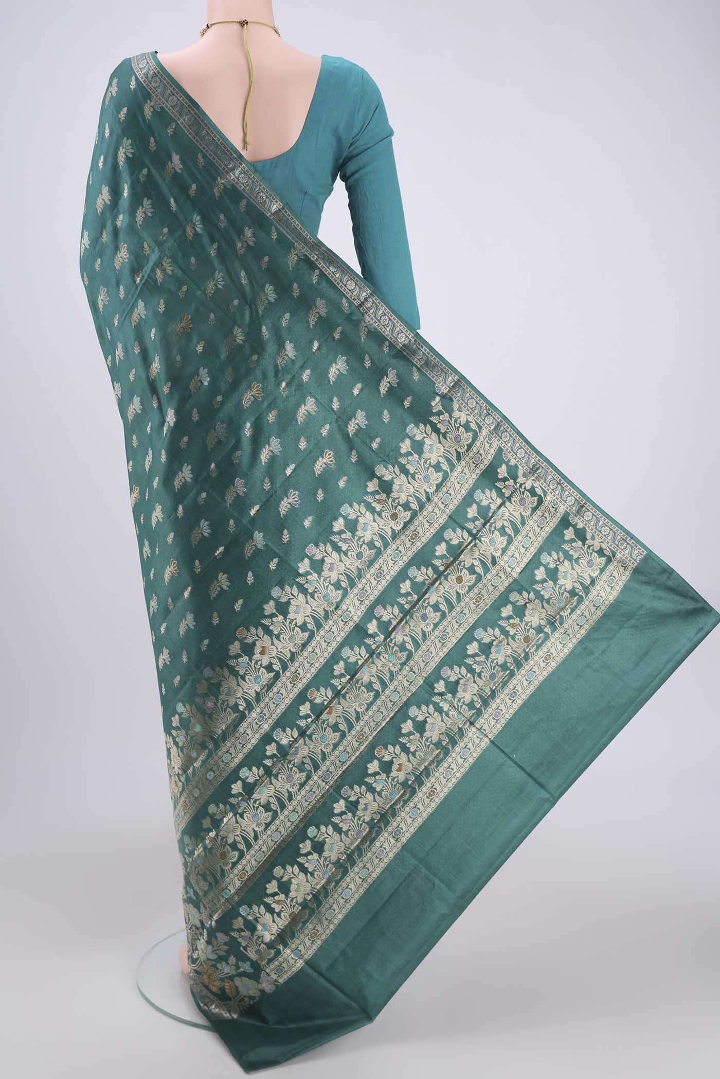 Flat view of Sea Green Banarasi Tussar Silk Saree with Zari And Thread Butta on the body and Zari And Thread Border. 