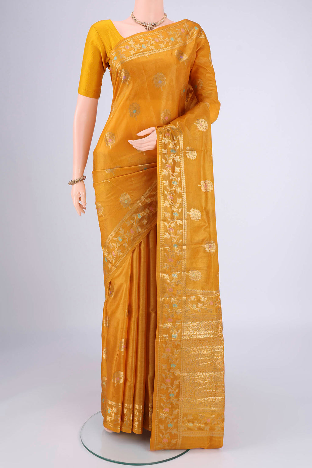 Yellow Banarasi Tussar Silk Saree with Zari And Thread Butta on the body and Zari And Thread Border.  displayed on a mannequin