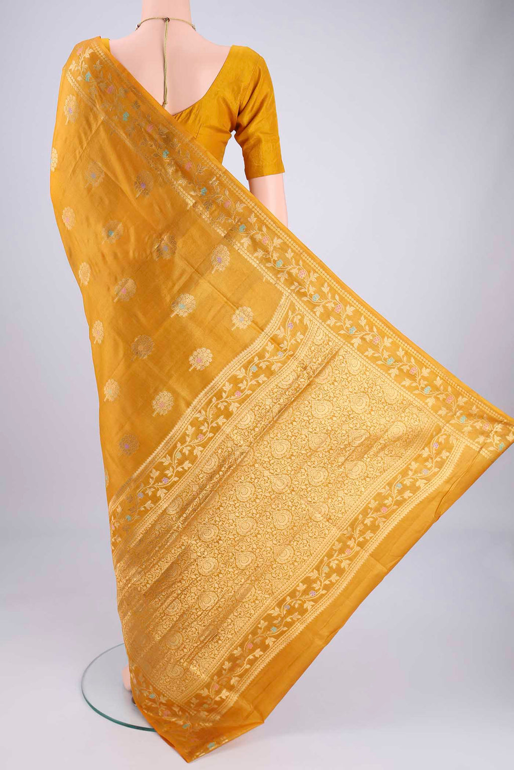 Flat view of Yellow Banarasi Tussar Silk Saree with Zari And Thread Butta on the body and Zari And Thread Border. 