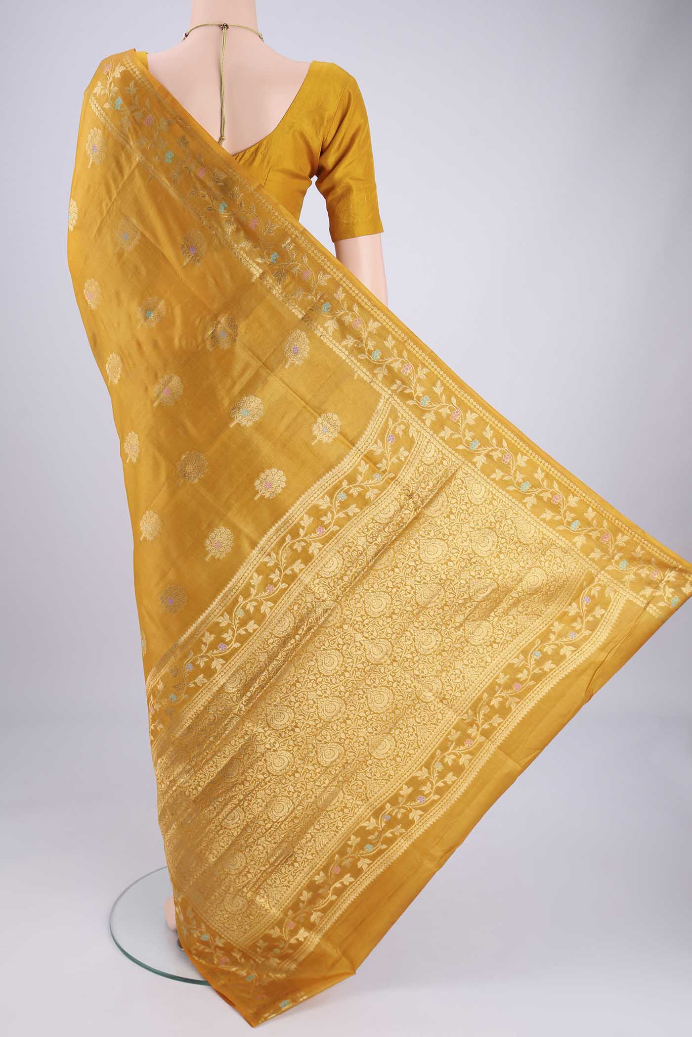 Flat view of Yellow Banarasi Tussar Silk Saree with Zari And Thread Butta on the body and Zari And Thread Border. 
