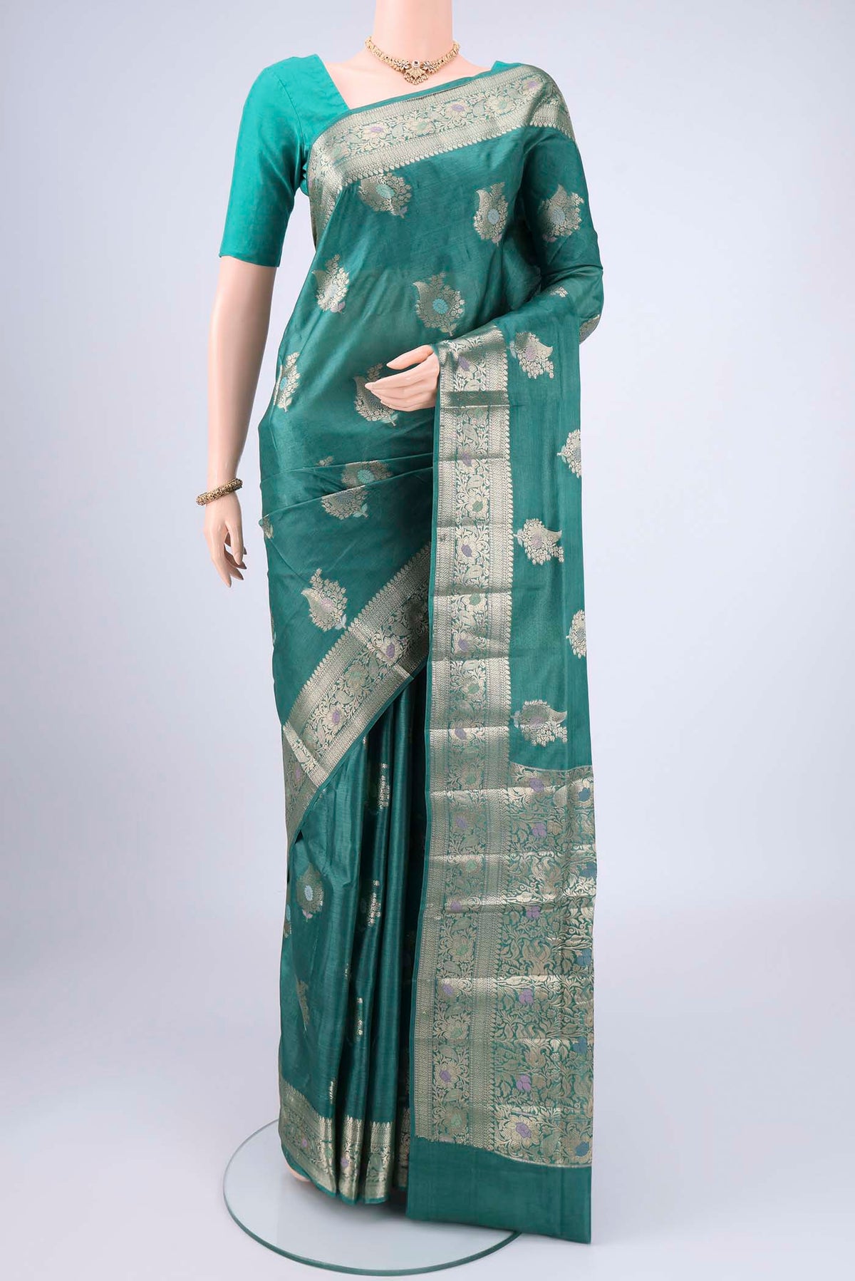 Green Banarasi Tussar Silk Saree with Zari And Thread Butta on the body and Zari And Thread Border.  displayed on a mannequin