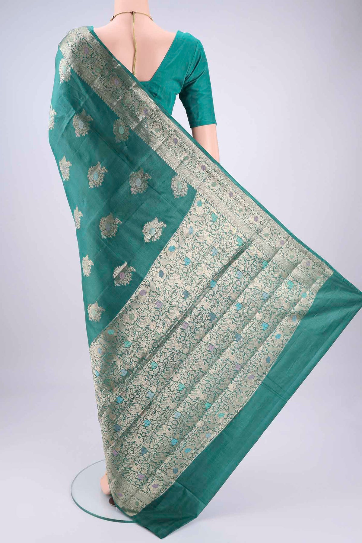 Flat view of Green Banarasi Tussar Silk Saree with Zari And Thread Butta on the body and Zari And Thread Border. 