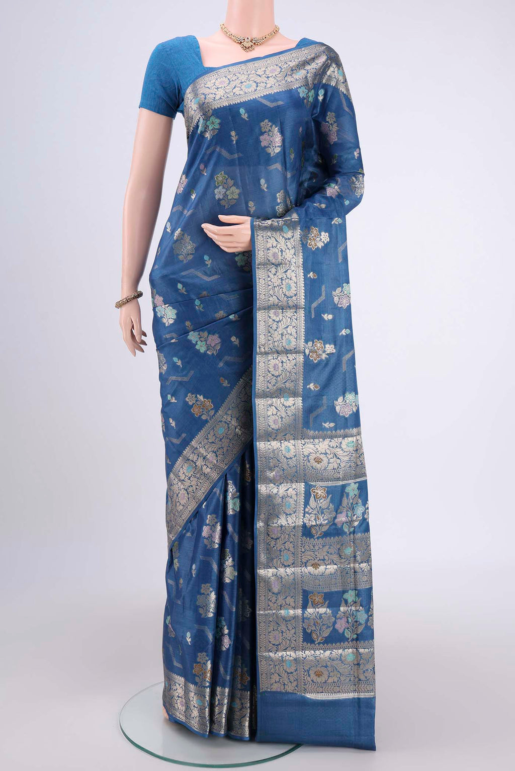 Blue Banarasi Tussar Silk Saree with Zari And Thread Butta on the body and Zari And Thread Border.  displayed on a mannequin