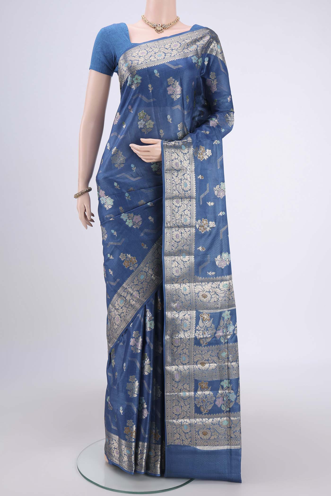 Blue Banarasi Tussar Silk Saree with Zari And Thread Butta on the body and Zari And Thread Border.  displayed on a mannequin