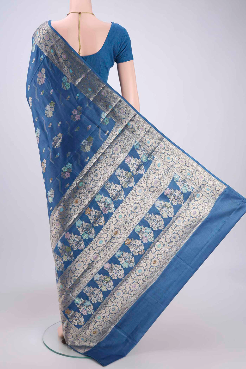 Flat view of Blue Banarasi Tussar Silk Saree with Zari And Thread Butta on the body and Zari And Thread Border. 