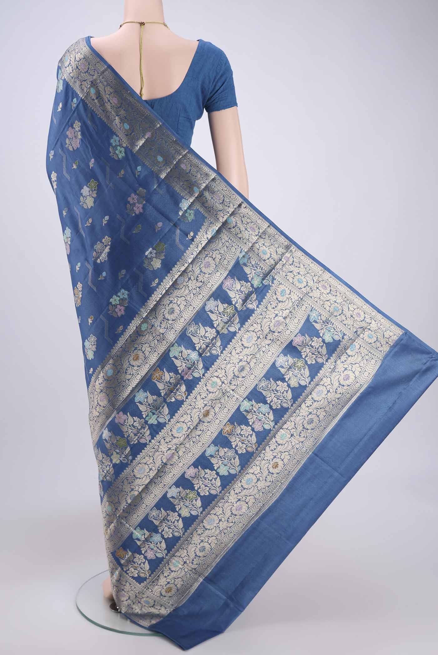 Flat view of Blue Banarasi Tussar Silk Saree with Zari And Thread Butta on the body and Zari And Thread Border. 