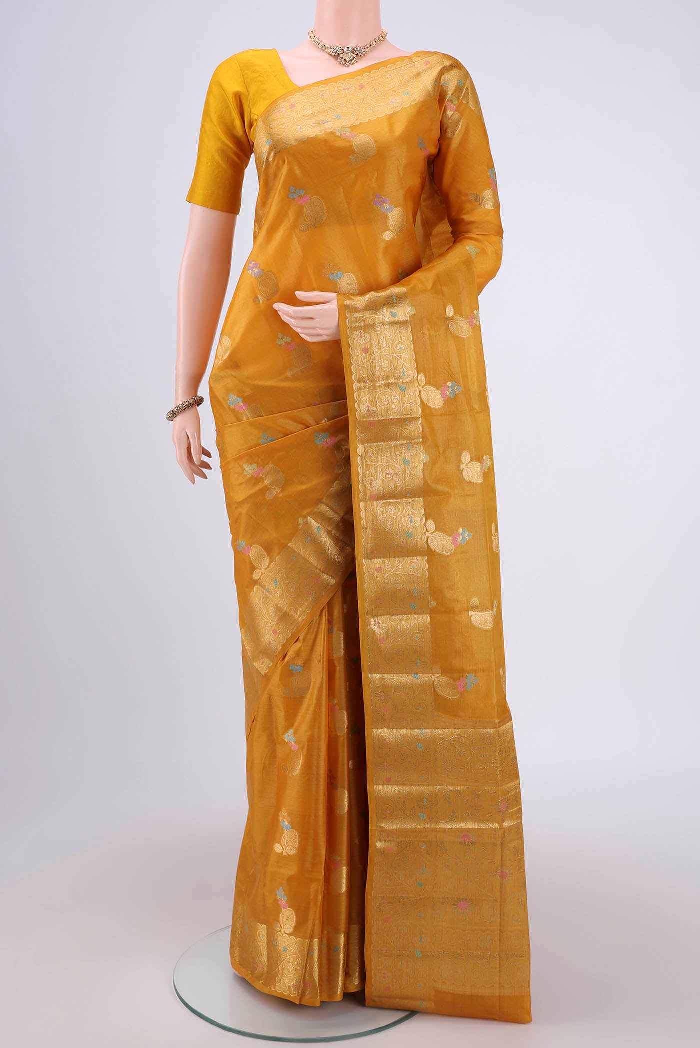 Yellow Banarasi Tussar Silk Saree with Zari And Thread Butta on the body and Zari And Thread Border.  displayed on a mannequin