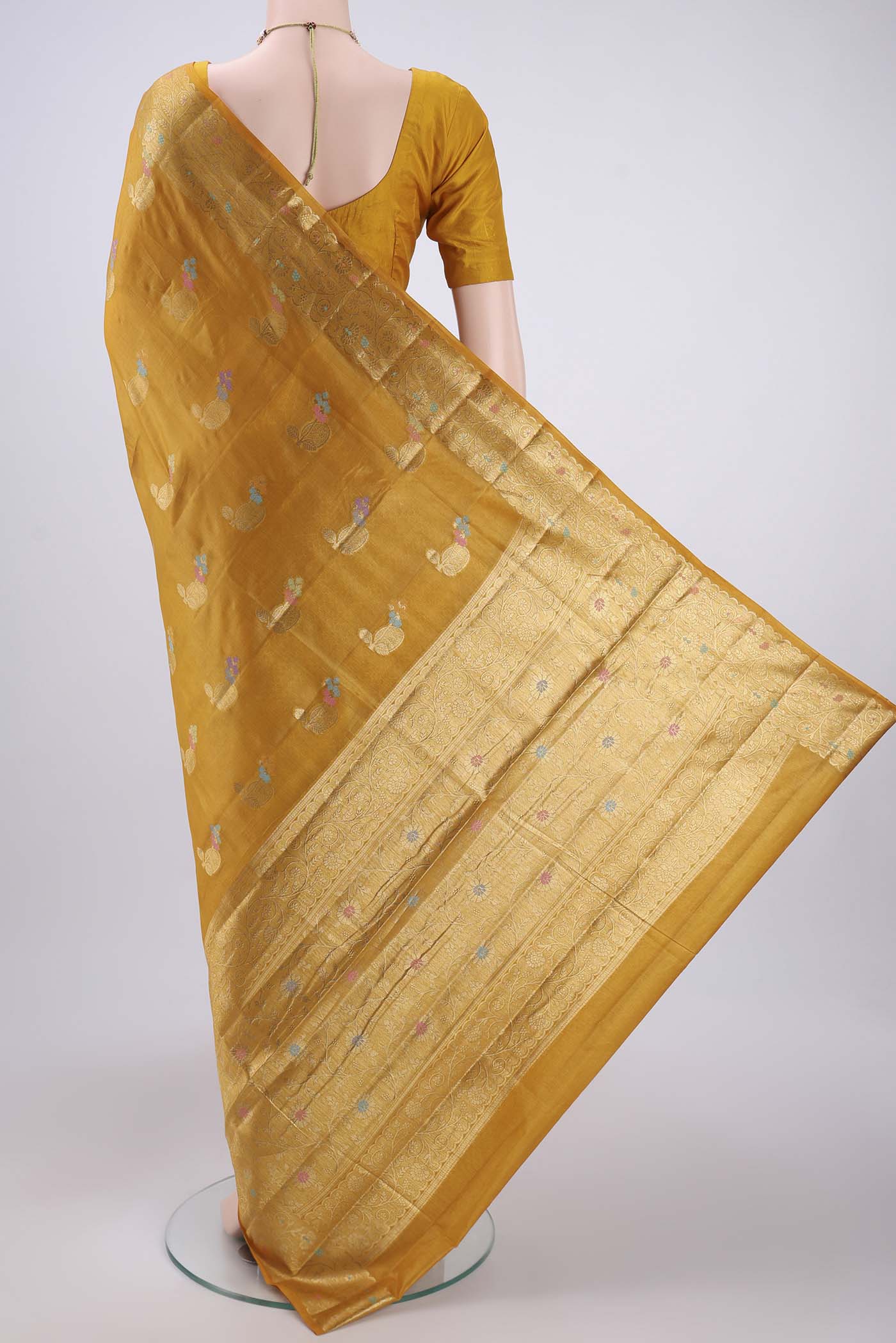 Flat view of Yellow Banarasi Tussar Silk Saree with Zari And Thread Butta on the body and Zari And Thread Border. 