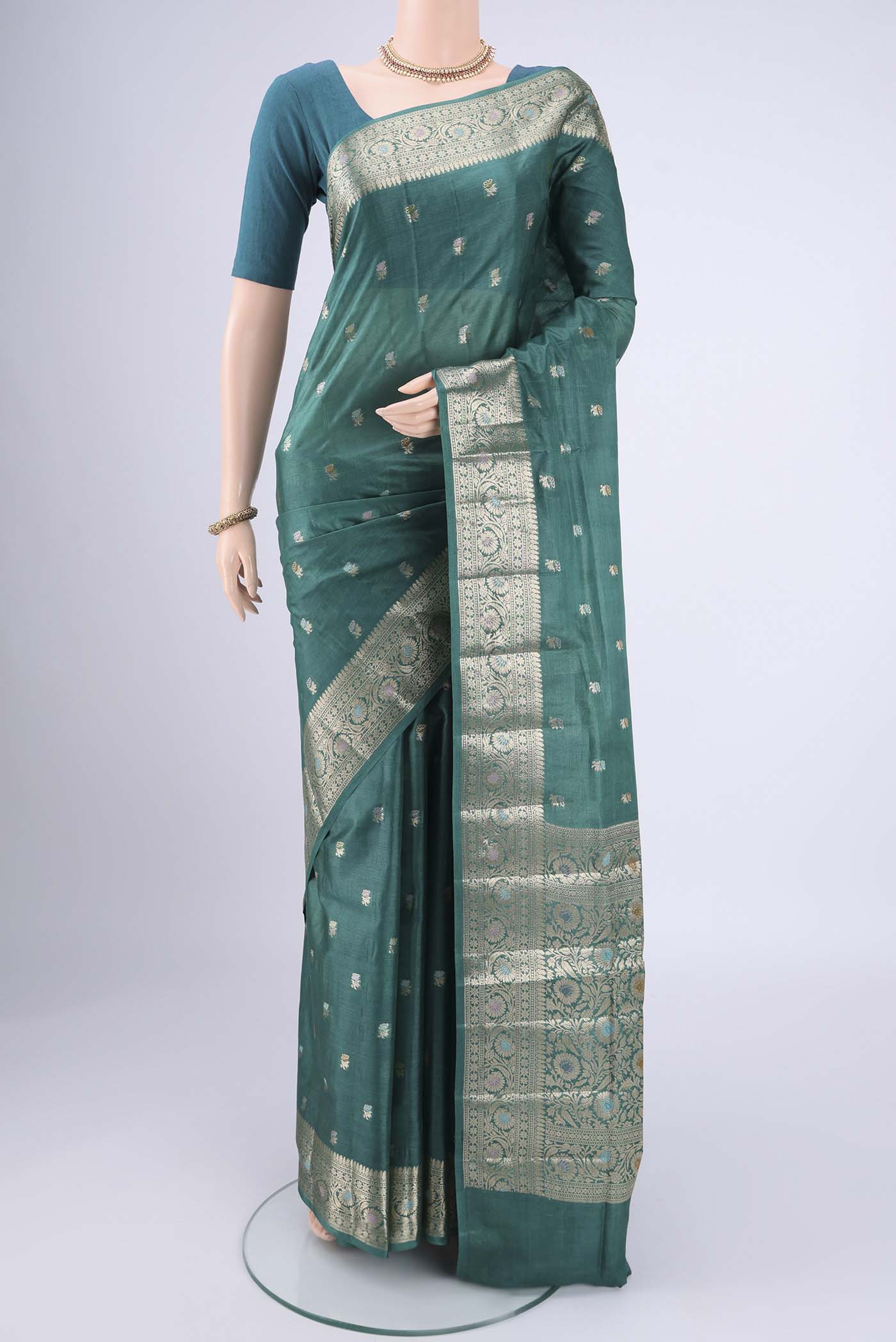 Green Banarasi Tussar Silk Saree with Zari Butta on the body and Zari And Thread Border.  displayed on a mannequin