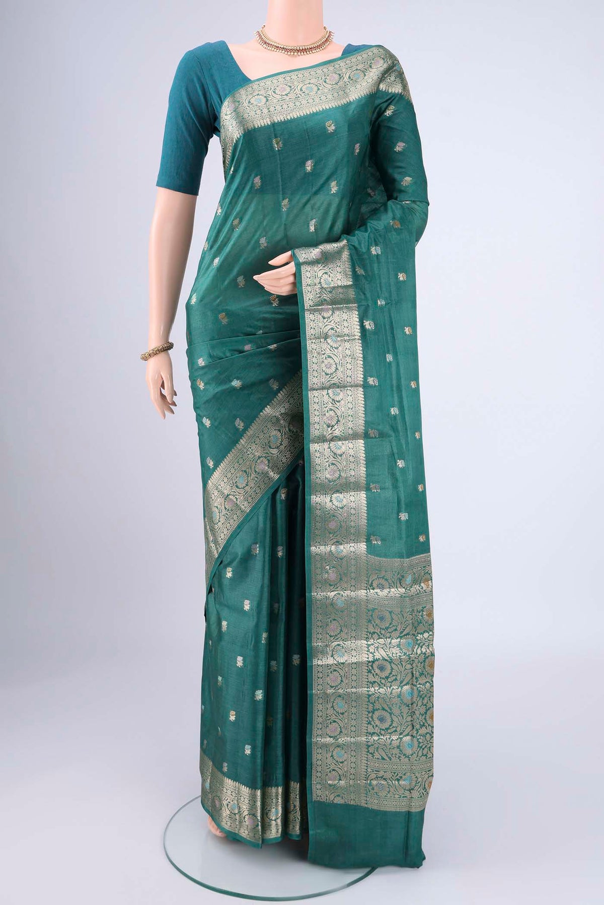 Green Banarasi Tussar Silk Saree with Zari Butta on the body and Zari And Thread Border.  displayed on a mannequin