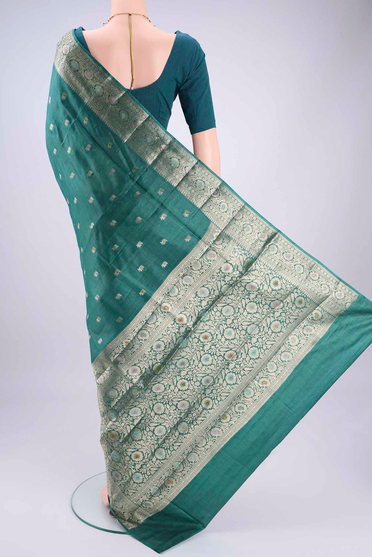 Flat view of Green Banarasi Tussar Silk Saree with Zari Butta on the body and Zari And Thread Border. 