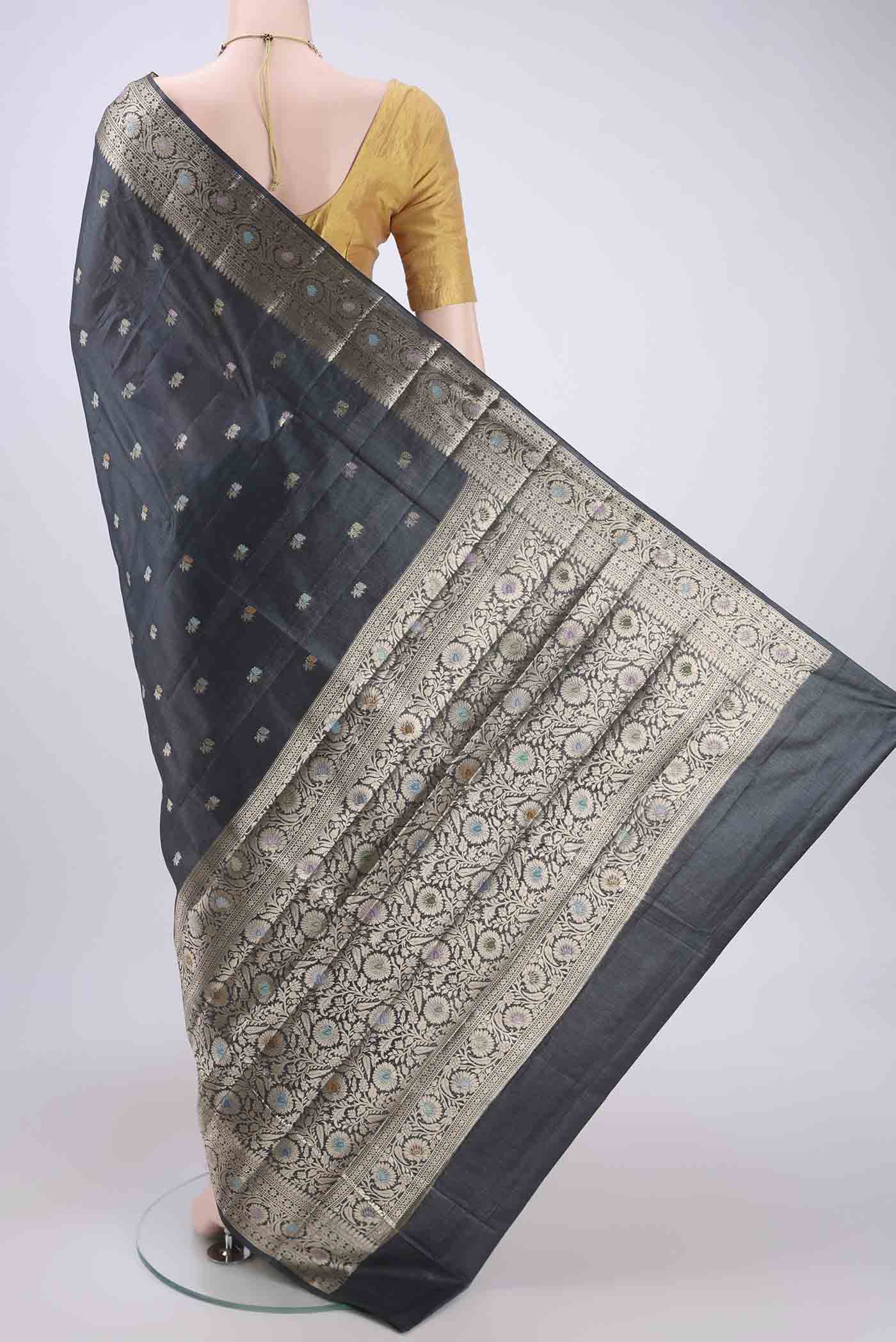 Flat view of Grey Banarasi Tussar Silk Saree with Thread Brocade on the body and Zari And Thread Border. 