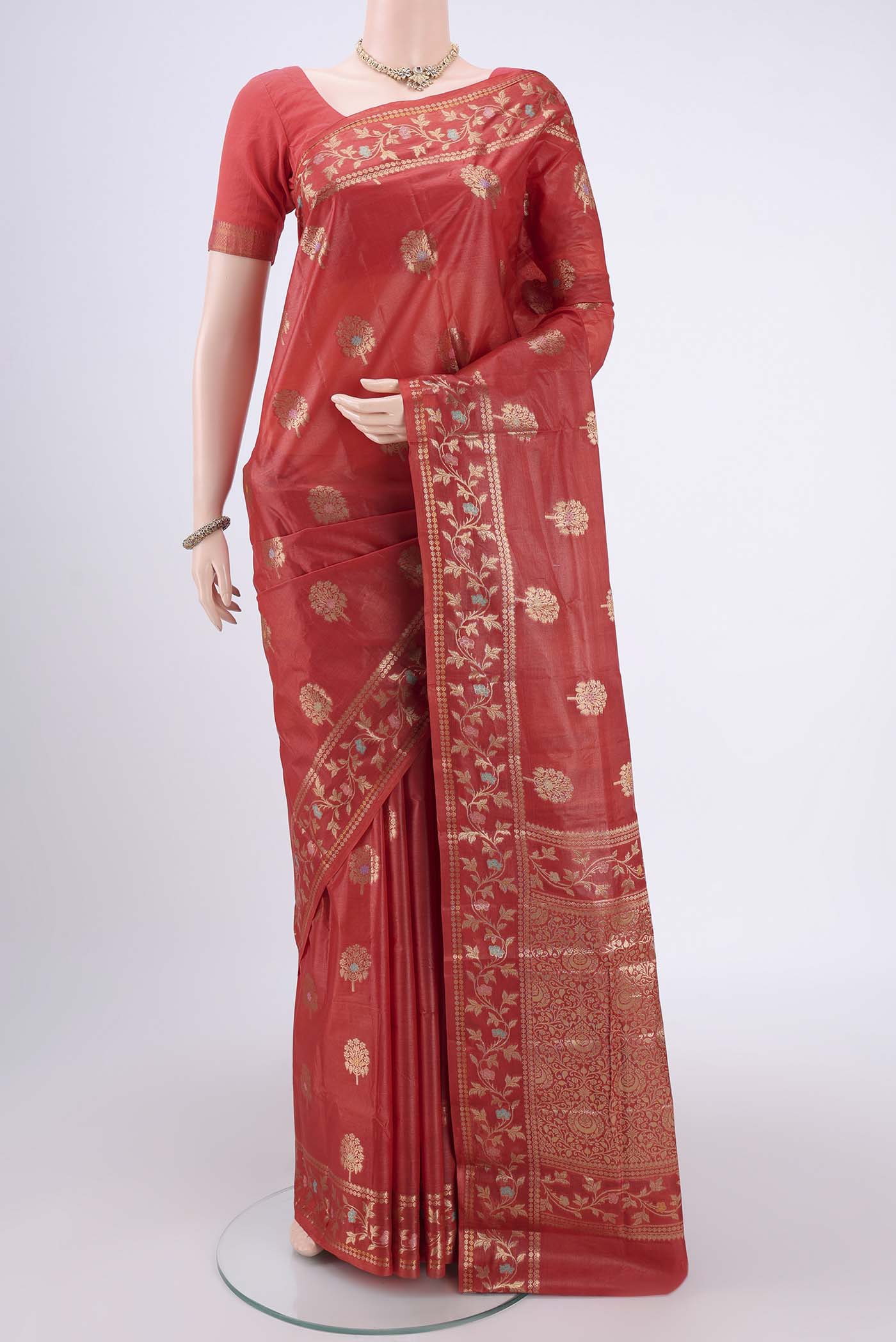 Orange Banarasi Tussar Silk Saree with Zari And Thread Butta on the body and Zari And Thread Border.  displayed on a mannequin
