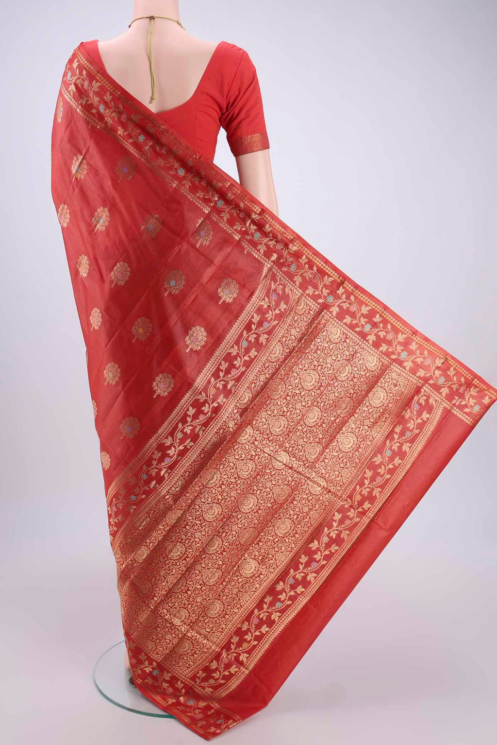 Flat view of Orange Banarasi Tussar Silk Saree with Zari And Thread Butta on the body and Zari And Thread Border. 
