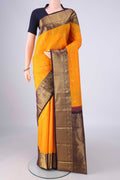 Yellow Kanchipuram Silk Saree with Zari Butta on the body and Zari Border.  displayed on a mannequin