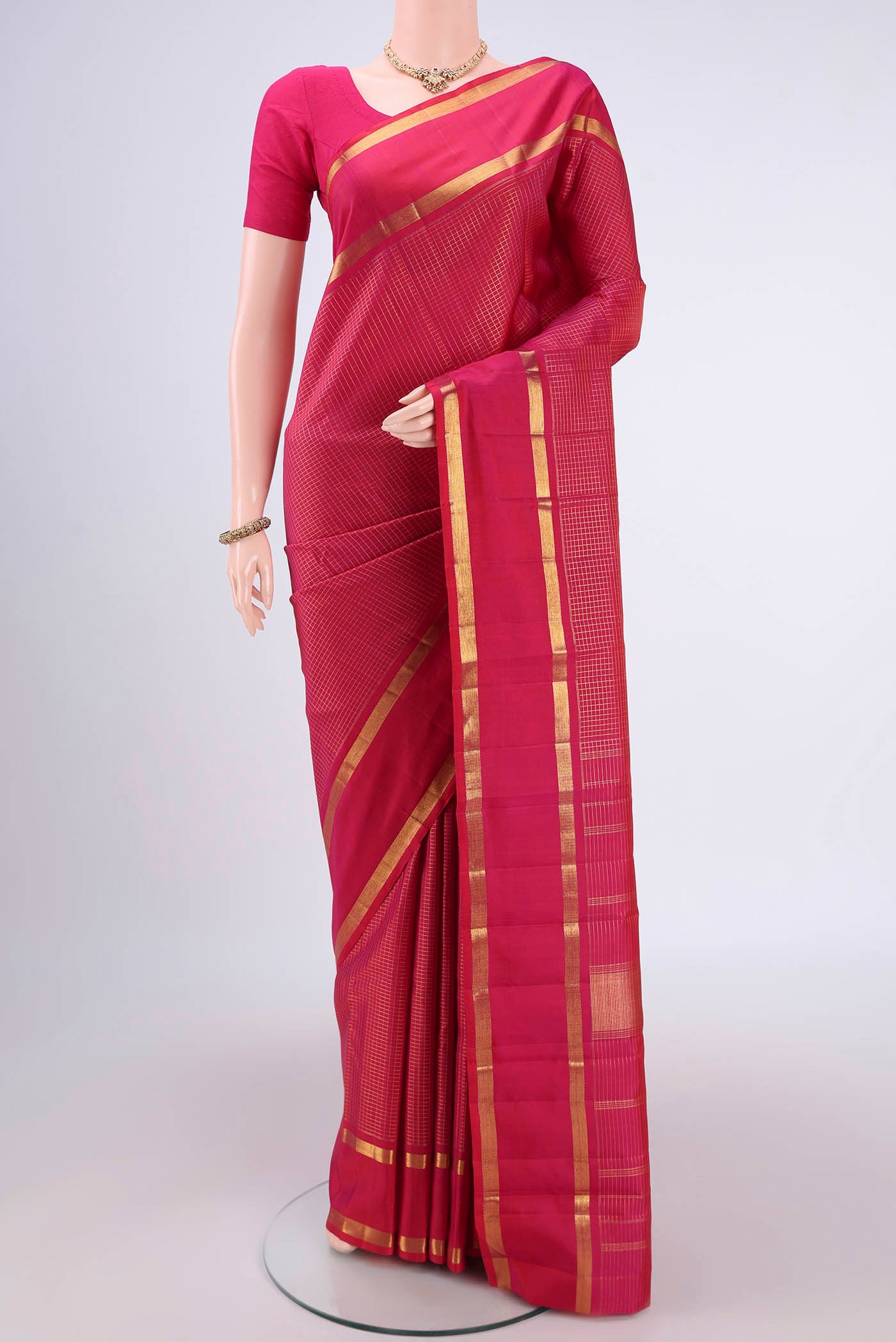 Pure Silk Pure Zari Dark Pink Kanjivaram Saree with Checked design on the body and Zari Border.  displayed on a mannequin